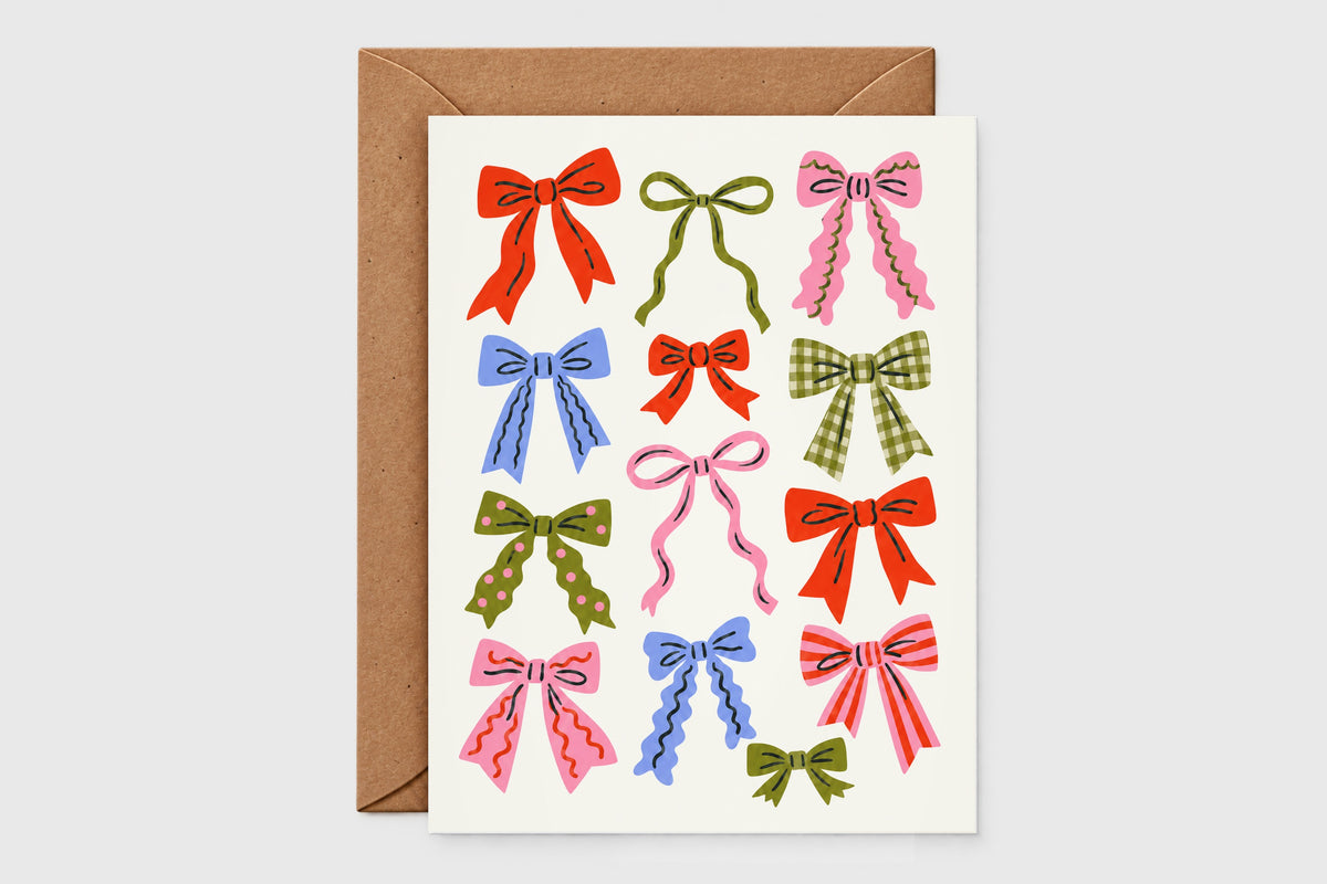 Holiday bows pattern Christmas card with red, pink, olive, and blue illustrated bows on a cream background