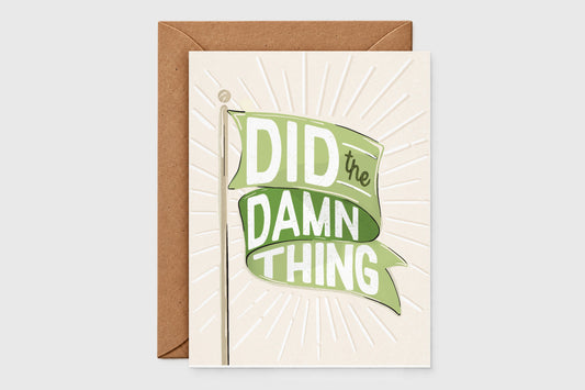 'Did the Damn Thing' congrats card with a green flag banner over an embossed sunburst on cream