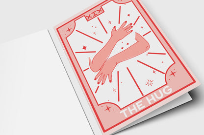 'The Hug' tarot-style card in pink and red with two arms in an embrace
