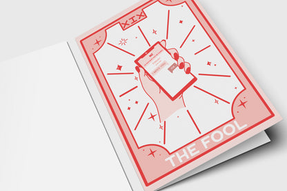 'The Fool' tarot-style breakup card in pink and red with a hand holding a phone