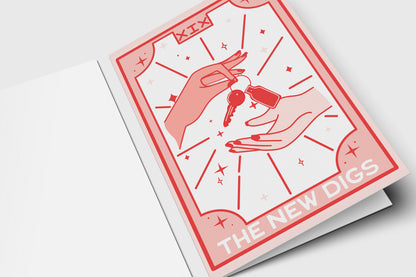 'The New Digs' tarot-style housewarming card in pink and red with hands passing keys