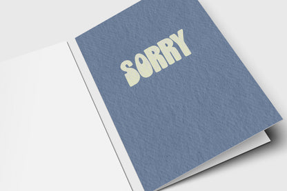Minimalist Sorry apology card with pale yellow retro letters on slate blue