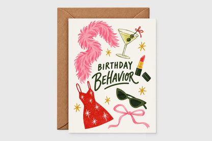 Birthday Behavior card with pink feather boa, martini, lipstick and red sparkly dress illustrations on a beige background