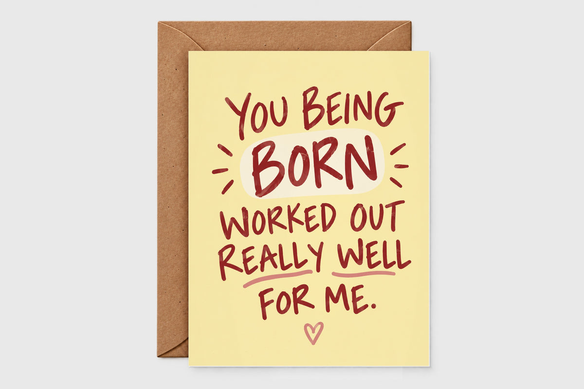Yellow birthday card reading You Being Born Worked Out Really Well For Me with red lettering and a heart