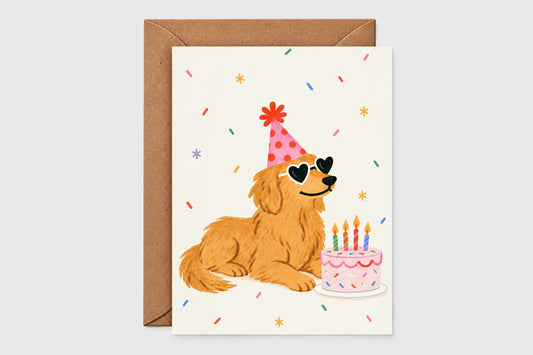Golden retriever birthday card with party hat, heart sunglasses and sprinkle cake on cream background