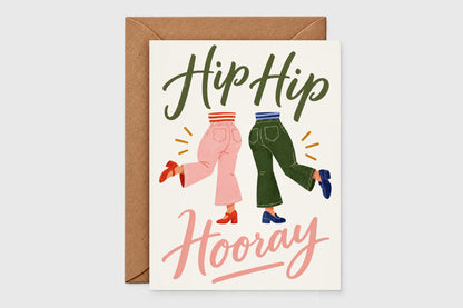 Hip Hip Hooray congratulations card with retro illustration of two dancing legs in pink and green pants on cream background