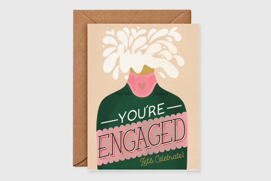You're Engaged Let's Celebrate card with a popping green champagne bottle on blush