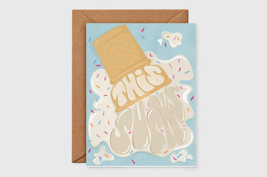 'This Sucks' sympathy card with a dropped ice cream cone melting into the words on light blue