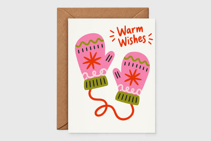 Warm Wishes holiday card with pink mittens connected by a red string on a cream background