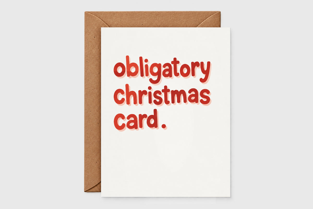 Obligatory Christmas Card with big red letters reading obligatory christmas card, with kraft envelope