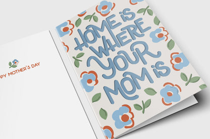 Home Is Where Your Mom Is Mother's Day card with blue hand lettering and folk florals